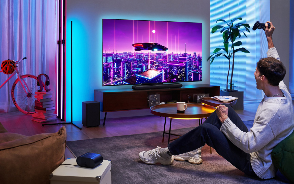 A man sitting on a couch, focused on playing a video game